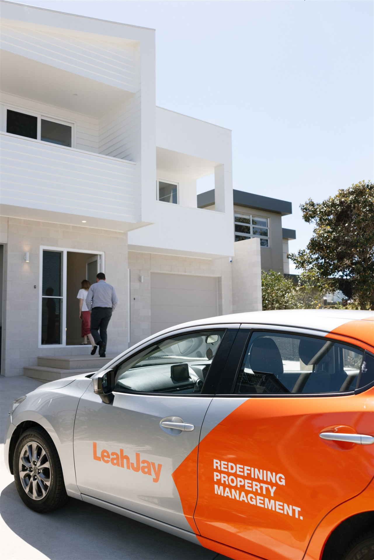 Branded Leah Jay vehicle parked outside a coastal home during an appraisal